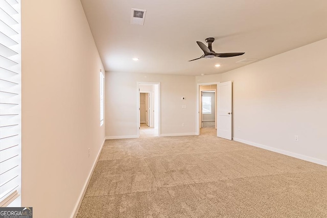 empty room with light carpet, visible vents, baseboards, and recessed lighting