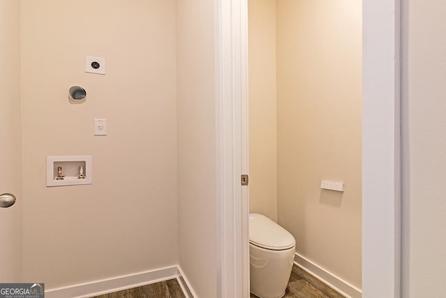 bathroom featuring wood finished floors, toilet, and baseboards