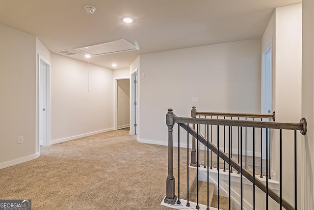 corridor with baseboards, carpet flooring, visible vents, and an upstairs landing