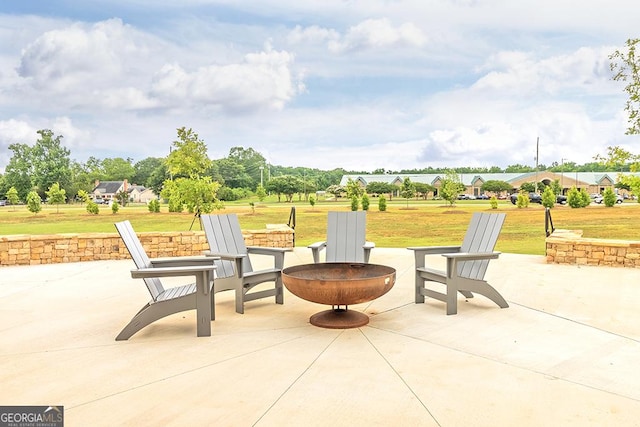 view of patio / terrace with an outdoor fire pit and a residential view