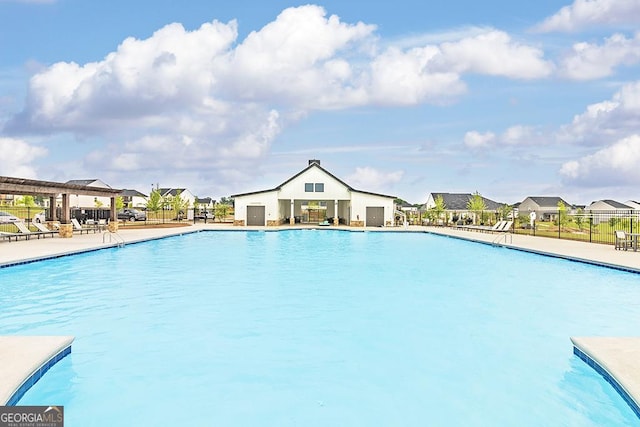 community pool featuring a residential view, fence, a patio, and a gazebo