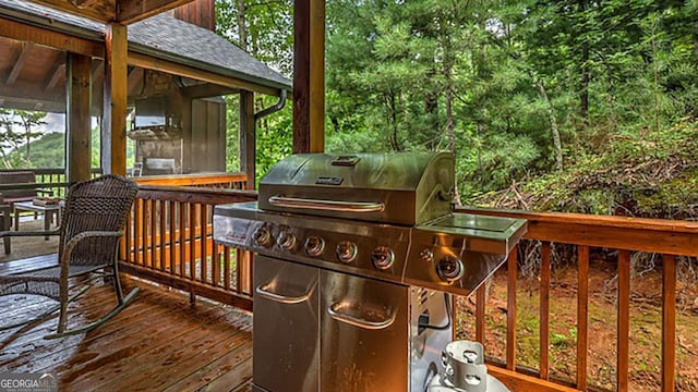 wooden terrace featuring area for grilling and a sunroom