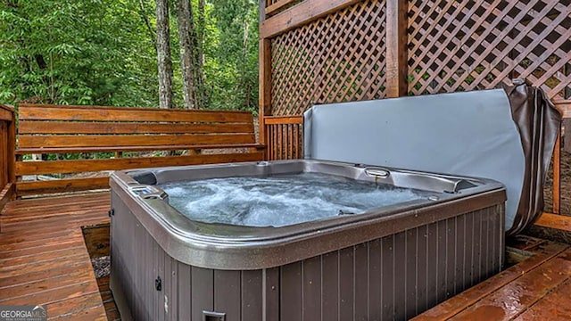 wooden deck featuring a hot tub