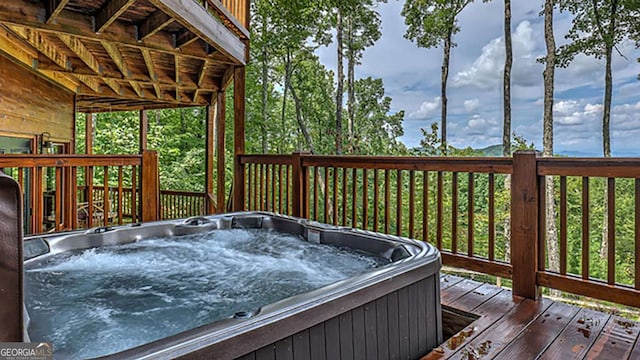 wooden terrace featuring a hot tub