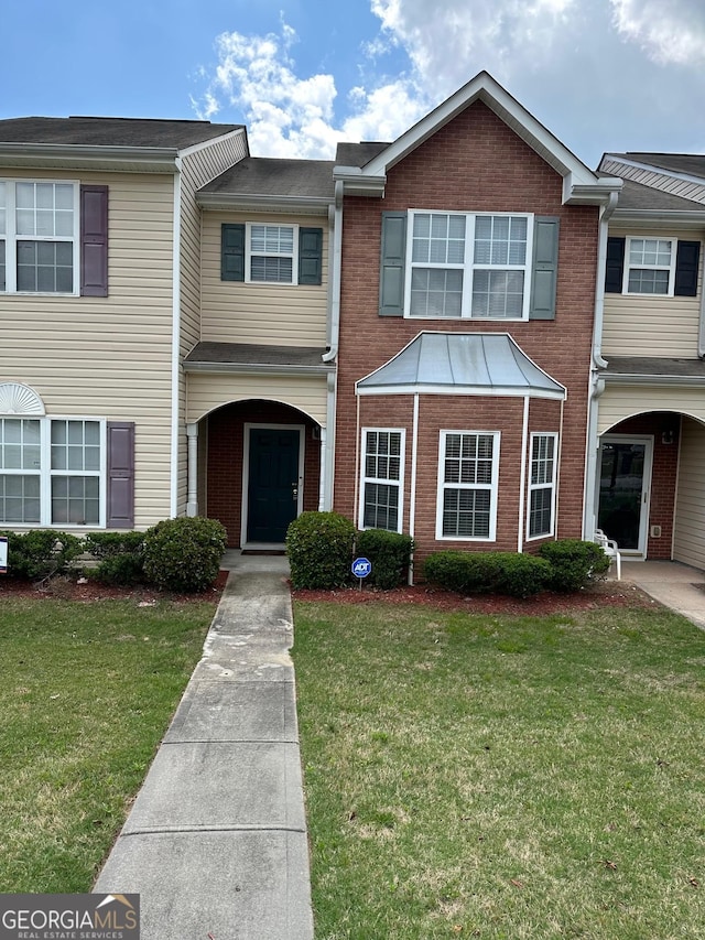 view of property featuring a front lawn