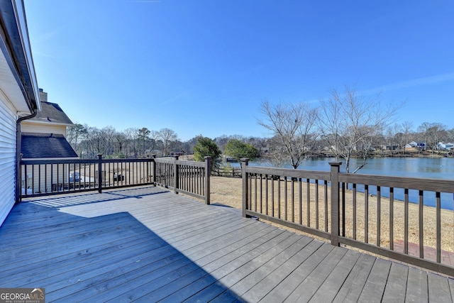 wooden terrace featuring a water view