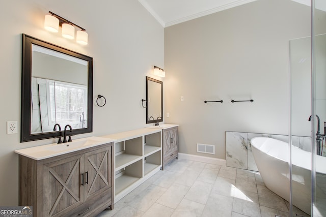 bathroom featuring a sink, baseboards, a freestanding bath, ornamental molding, and double vanity