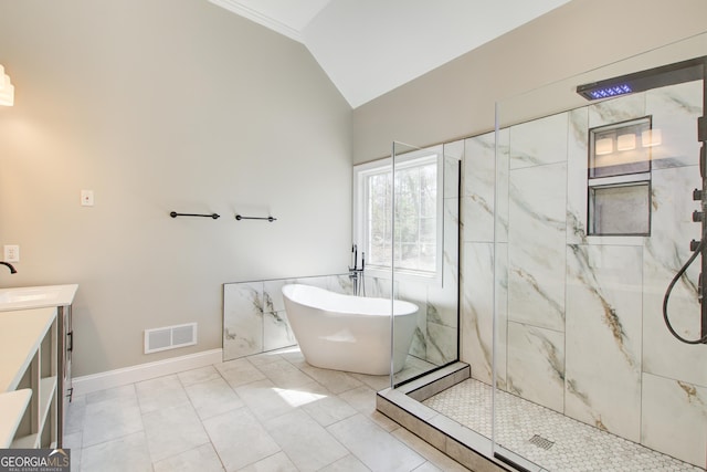 full bath featuring a marble finish shower, visible vents, a freestanding bath, vaulted ceiling, and vanity