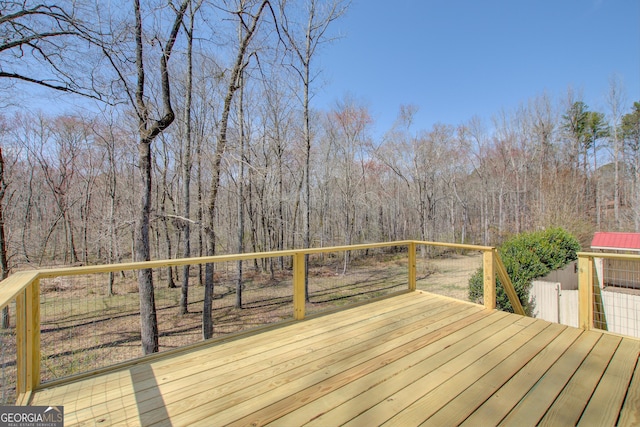 wooden terrace with a view of trees