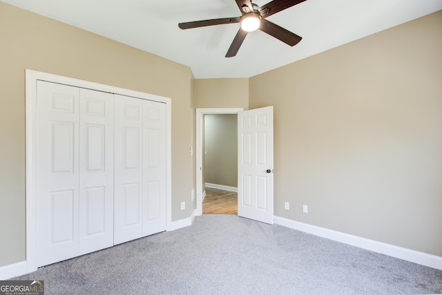 unfurnished bedroom featuring carpet floors, a closet, ceiling fan, and baseboards