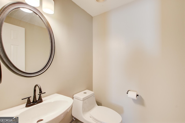 bathroom featuring toilet and a sink