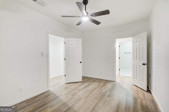 unfurnished bedroom with light wood finished floors, visible vents, and baseboards