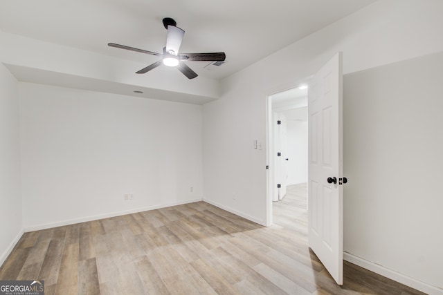 interior space featuring ceiling fan, light wood finished floors, and baseboards