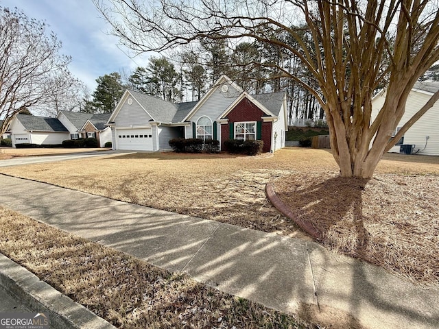 view of front of home featuring central air condition unit and a garage