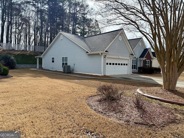 view of property exterior with cooling unit and a garage