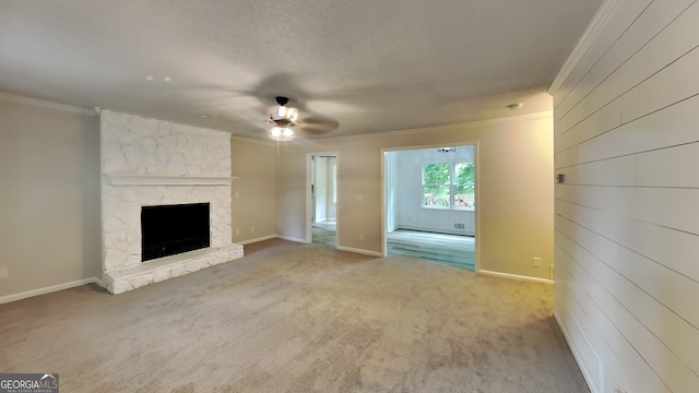 unfurnished living room with a fireplace, ornamental molding, light carpet, and a textured ceiling