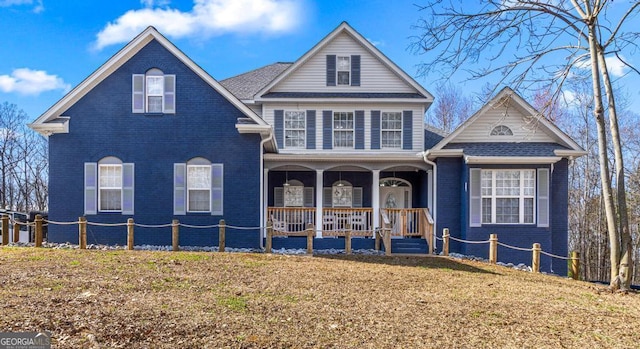 front of property with covered porch and a front lawn