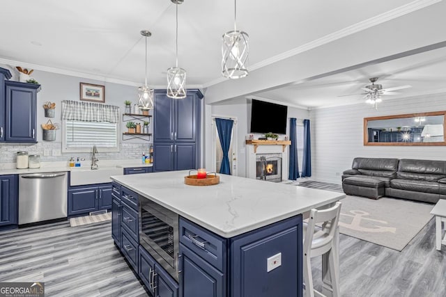 kitchen featuring blue cabinetry, appliances with stainless steel finishes, and sink