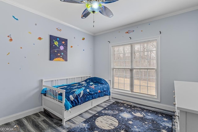 bedroom with hardwood / wood-style flooring, crown molding, and ceiling fan