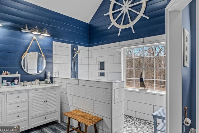 bathroom with vaulted ceiling and vanity