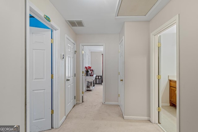 hallway featuring light carpet