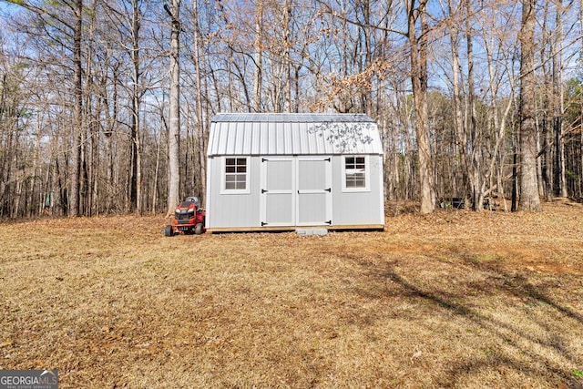 view of outdoor structure featuring a lawn