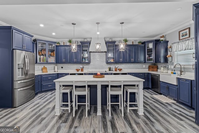 kitchen with a center island, sink, dishwasher, and stainless steel fridge with ice dispenser