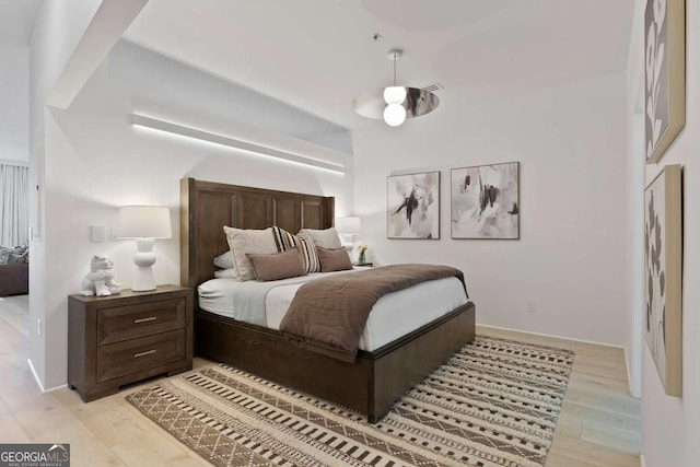 bedroom featuring light wood-style flooring and baseboards