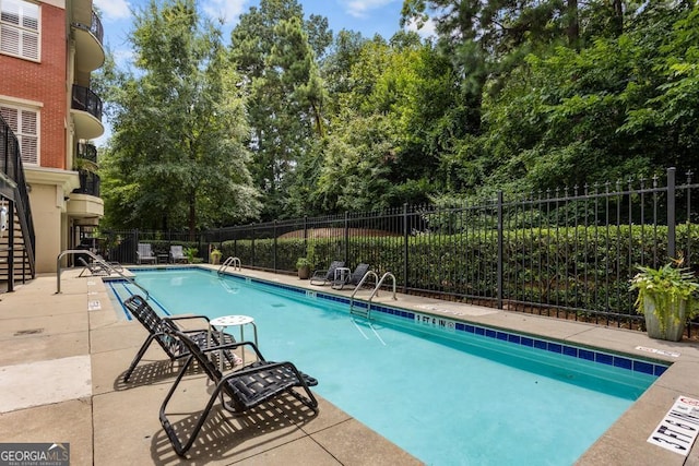 pool featuring a patio and fence