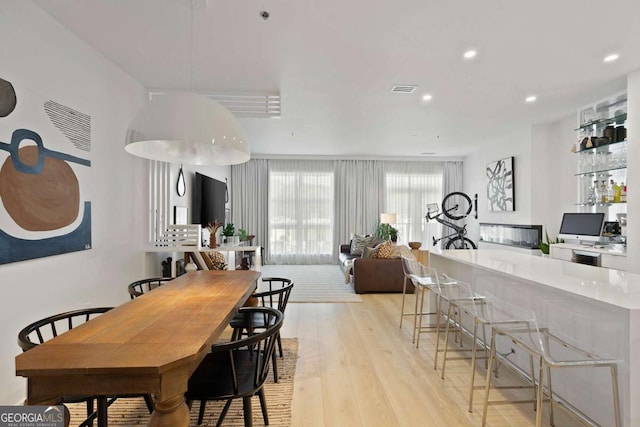 dining room with visible vents, recessed lighting, and light wood-type flooring