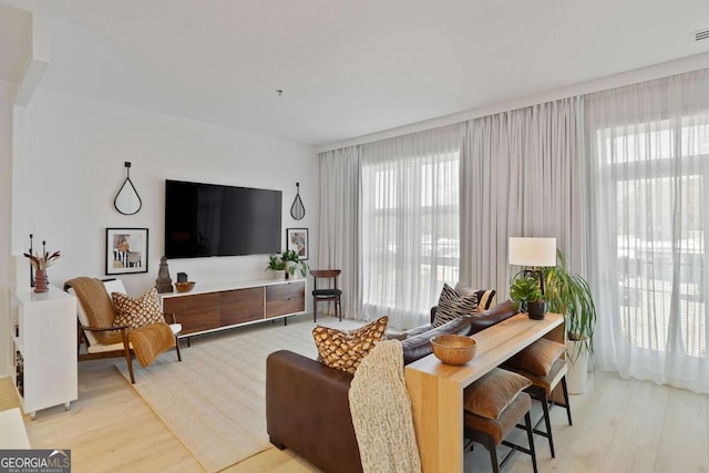 living room featuring visible vents and light wood-type flooring