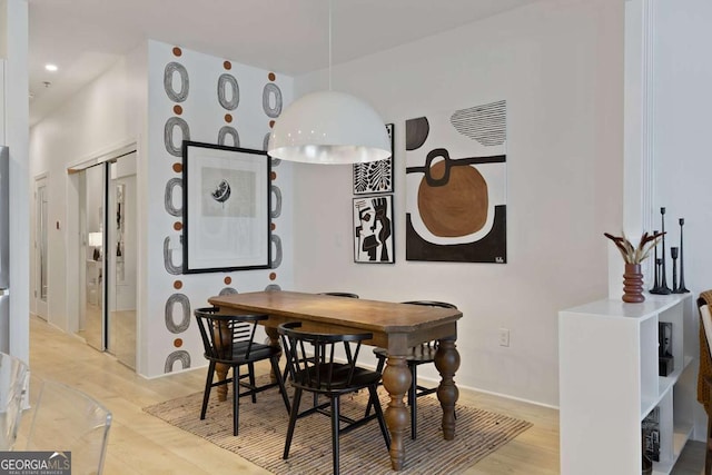 dining area featuring light wood-style floors