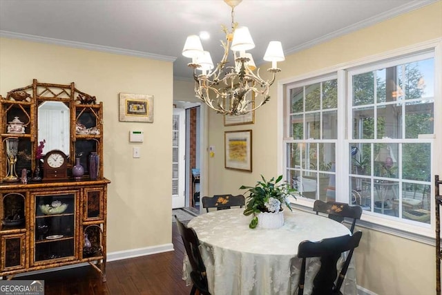 dining area with a notable chandelier, ornamental molding, and dark wood-type flooring