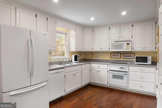 kitchen featuring sink, white appliances, dark hardwood / wood-style floors, and white cabinets