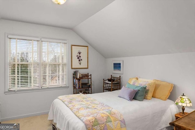 carpeted bedroom featuring multiple windows and lofted ceiling