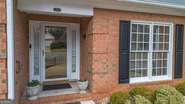 property entrance with brick siding