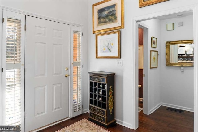 foyer entrance featuring dark hardwood / wood-style floors