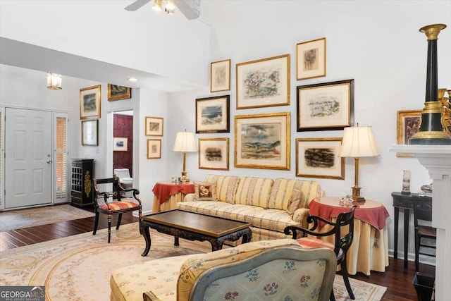 living room with ceiling fan and dark hardwood / wood-style floors