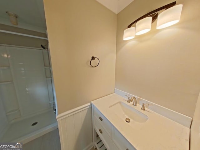 bathroom with vanity and a shower