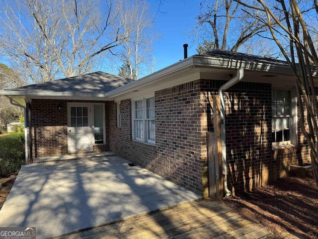 view of side of property featuring a wooden deck