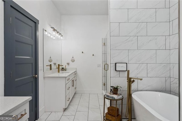 full bath with marble finish floor, a freestanding bath, a shower stall, vanity, and baseboards