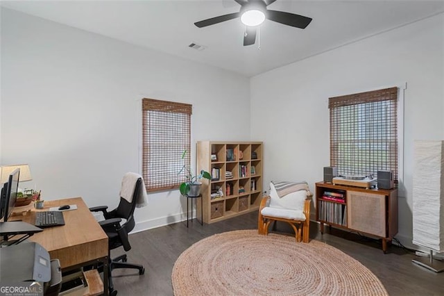 office area featuring dark wood-type flooring, a ceiling fan, and baseboards