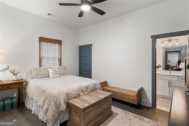 bedroom with baseboards, visible vents, a ceiling fan, dark wood-style floors, and ensuite bathroom