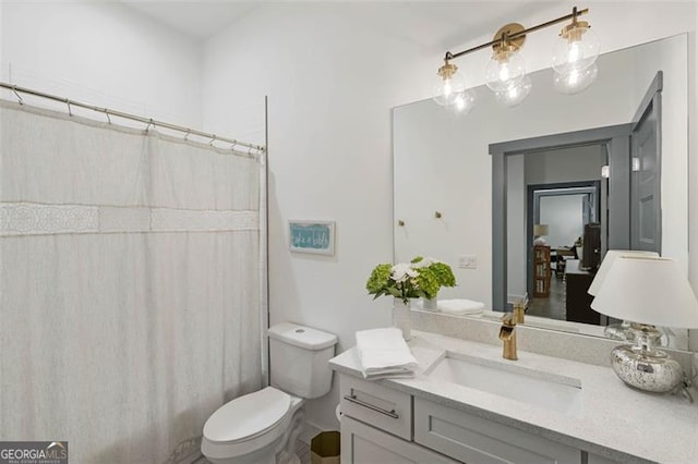 full bathroom with curtained shower, vanity, and toilet