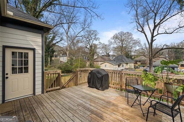 wooden deck with a residential view and area for grilling