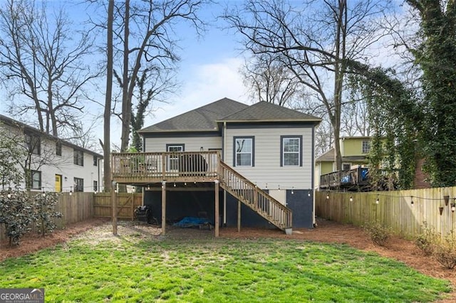 rear view of house featuring a fenced backyard, stairs, a wooden deck, and a yard