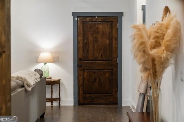 interior space featuring dark wood-style floors and baseboards