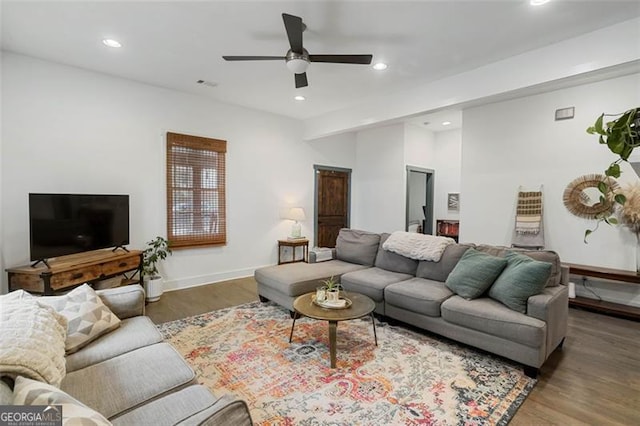 living room featuring a ceiling fan, dark wood-style flooring, visible vents, and recessed lighting