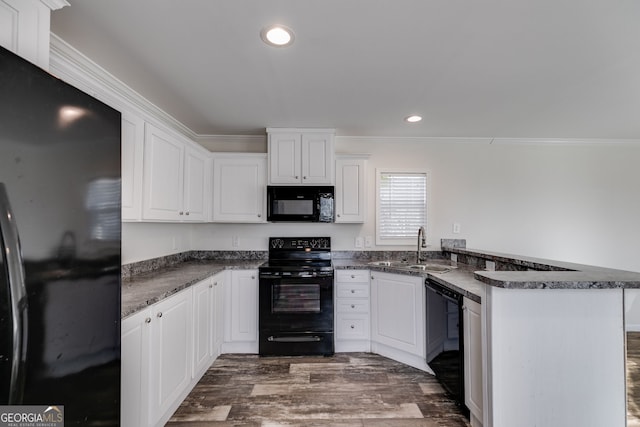 kitchen with white cabinets, sink, black appliances, and kitchen peninsula