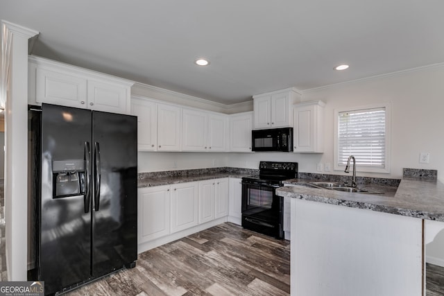 kitchen with black appliances, sink, white cabinetry, dark hardwood / wood-style floors, and kitchen peninsula